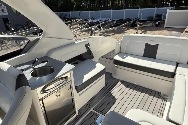 Slide: The Image of 2016 Chaparral 307 SSX boat interior with seating, sink, and storage. - 41