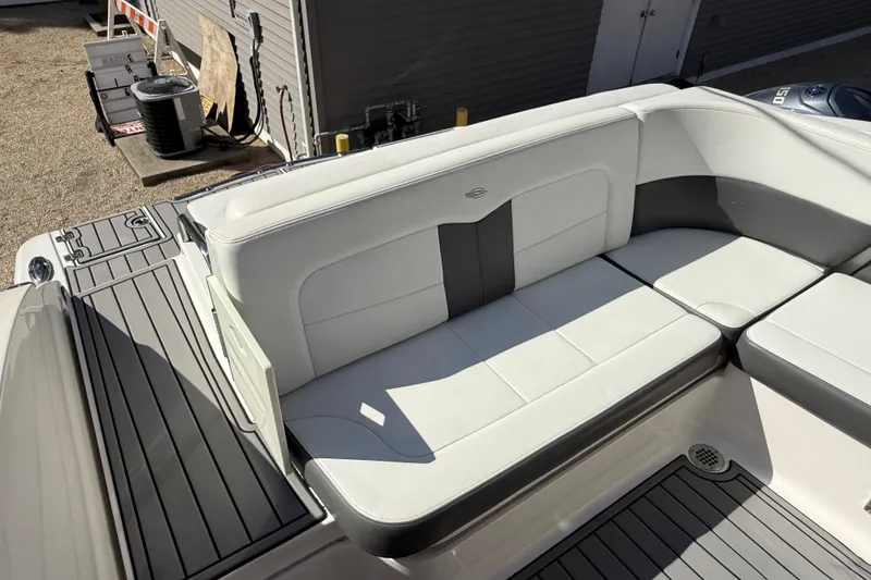 Slide: The Image of 2016 Chaparral 307 SSX boat interior with white and gray seating. - 45