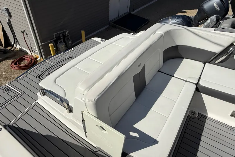 Slide: The Image of 2016 Chaparral 307 SSX boat interior with white seating and gray flooring. - 46