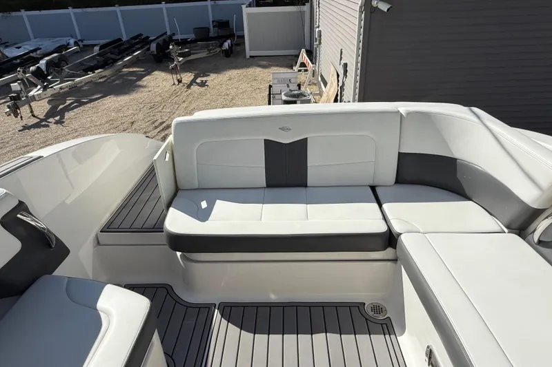 Slide: The Image of 2016 Chaparral 307 SSX boat interior with white and gray seating. - 47