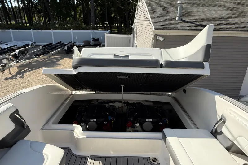 Slide: The Image of 2016 Chaparral 307 SSX boat engine compartment with open hatch, showcasing dual engines. - 48