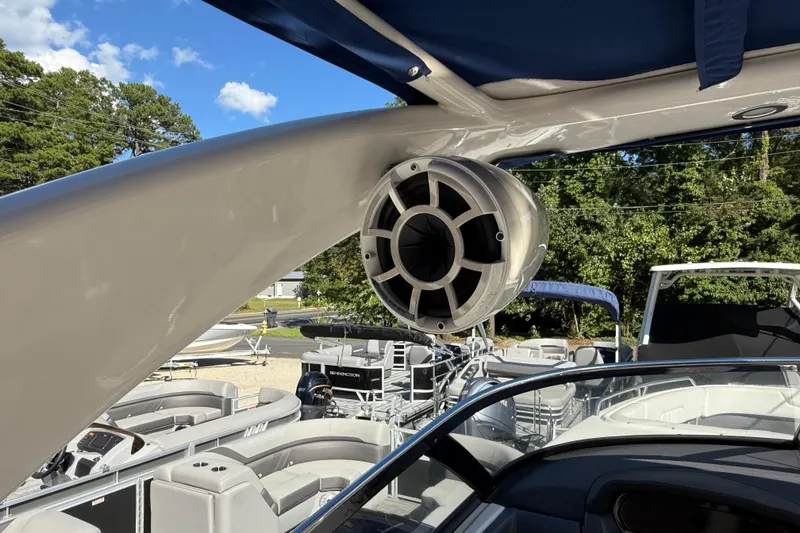 Slide: The Image of 2016 Chaparral 307 SSX boat with speaker system, featuring sleek design and outdoor setting. - 54