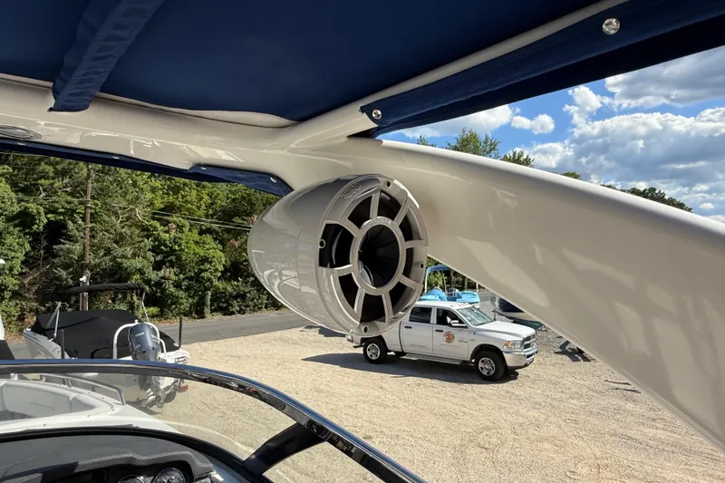 Slide: The Image of 2016 Chaparral 307 SSX boat speaker and canopy, with vehicles in the background. - 55