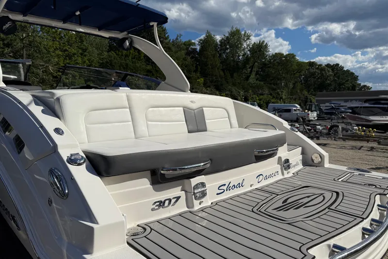 Slide: The Image of 2016 Chaparral 307 SSX boat with white seating and custom name "Shoal Dancer." - 56