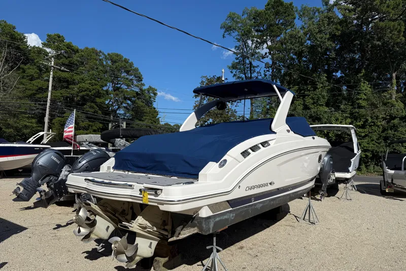 Slide: The Image of 2016 Chaparral 307 SSX boat with blue cover, parked outdoors on stands. - 57