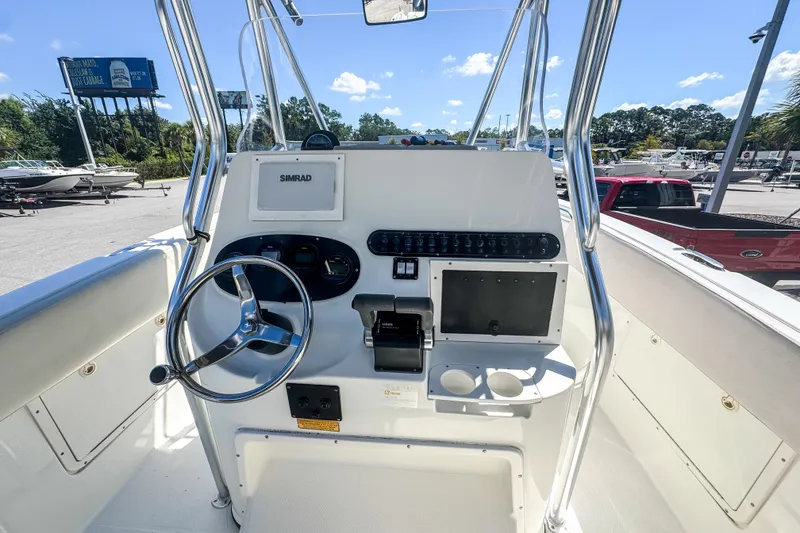 Slide: The Image of 2003 Triton 2895 CC boat console with steering wheel and navigation equipment. - 17