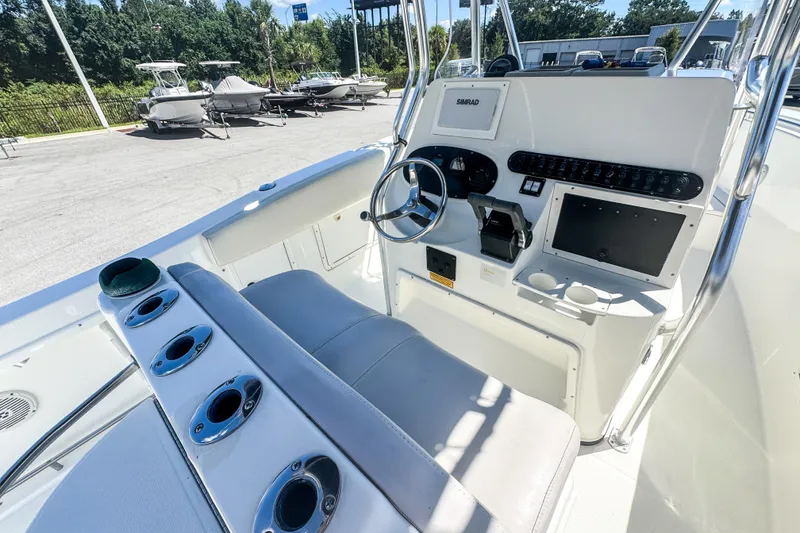 Slide: The Image of 2003 Triton 2895 CC boat cockpit with steering wheel and control panel. - 18