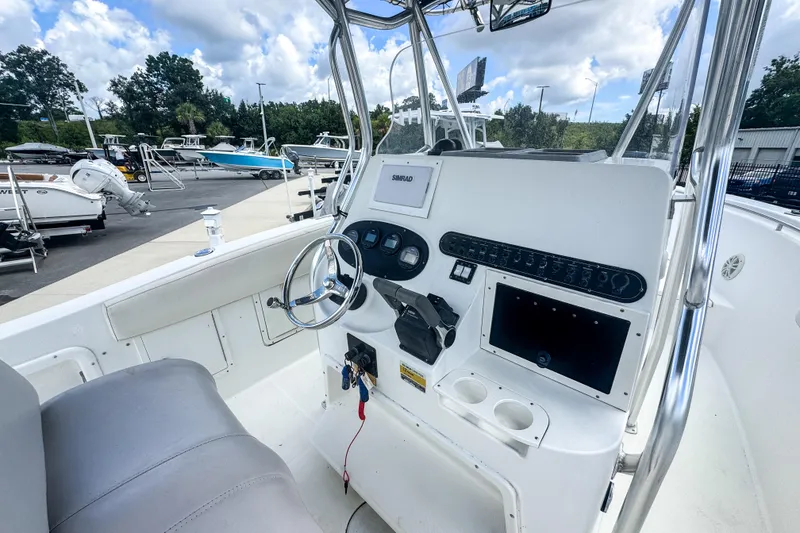 Slide: The Image of 2003 Triton 2895 CC boat cockpit with steering wheel and control panel. - 5