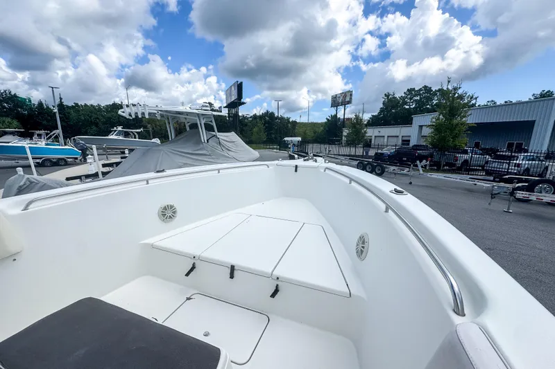 Slide: The Image of 2003 Triton 2895 CC boat interior with clear sky and surrounding boats. - 6
