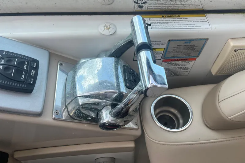 Slide: The Image of 2012 Formula 34 Performance Cruiser throttle controls and cup holder. - 16