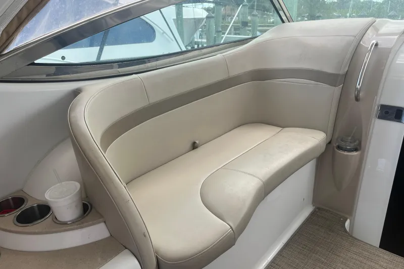Slide: The Image of 2012 Formula 34 Performance Cruiser interior seating with cup holders and beige upholstery. - 24