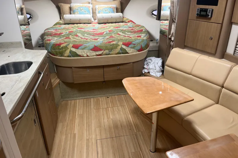 Slide: The Image of Interior of a 2012 Formula 34 Performance Cruiser with cozy seating and a colorful bedspread. - 28