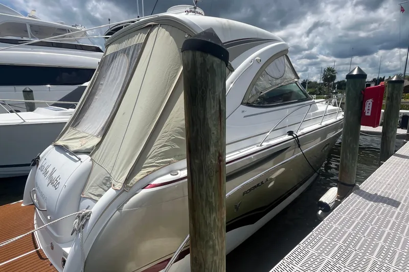 Slide: The Image of 2012 Formula 34 Performance Cruiser docked at marina under cloudy sky. - 3