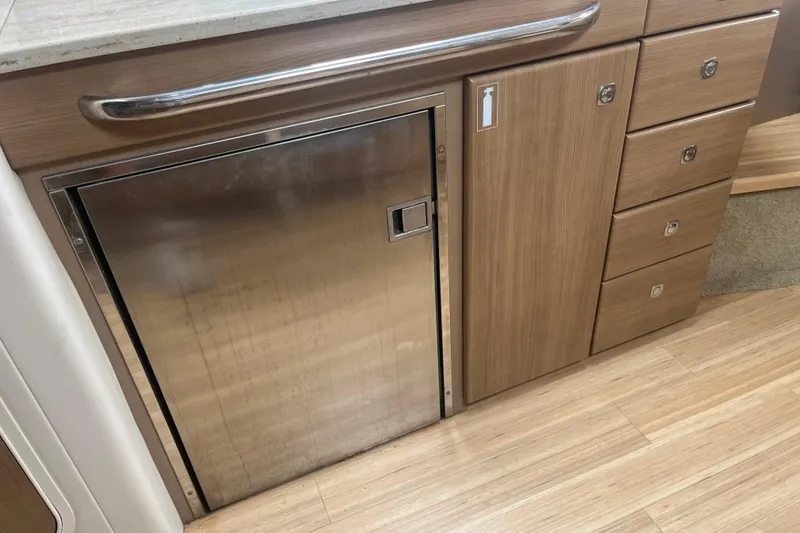 Slide: The Image of 2012 Formula 34 Performance Cruiser interior with stainless steel fridge and wooden cabinetry. - 32