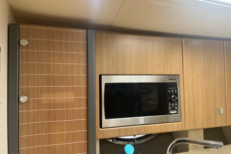 Slide: The Image of 2012 Formula 34 Performance Cruiser kitchen with wood cabinets and built-in microwave. - 33