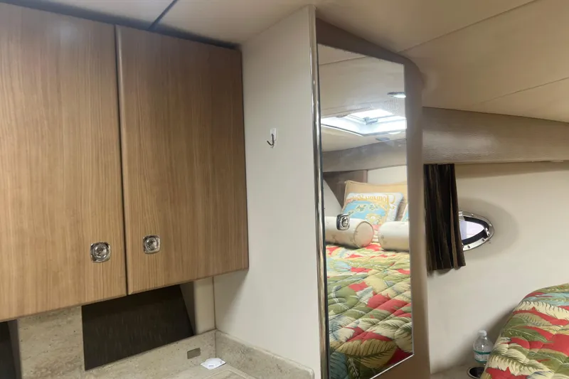 Slide: The Image of Interior of 2012 Formula 34 Performance Cruiser with wood cabinets and colorful bedding. - 34