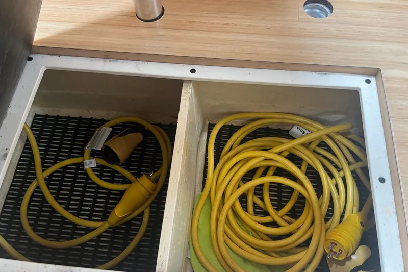 Slide: The Image of Storage compartment with yellow power cables on a 2012 Formula 34 Performance Cruiser. - 39