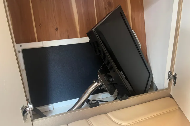 Slide: The Image of TV mounted inside a cabinet on a 2012 Formula 34 Performance Cruiser. - 44