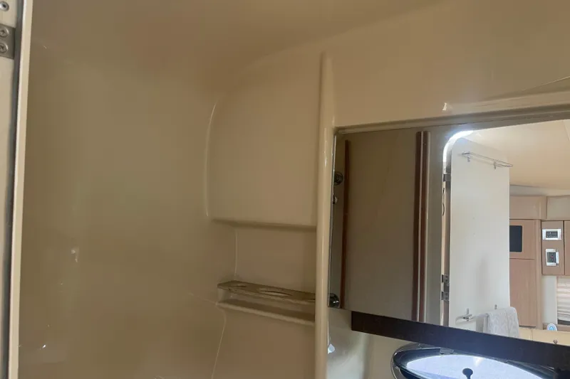 Slide: The Image of Interior of 2012 Formula 34 Performance Cruiser, featuring a compact bathroom with shelving. - 48