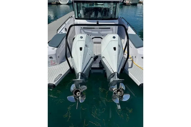 Slide: The Image of 2024 Axopar 37 XC Cross Cabin Wet Bar with dual outboard engines. - 10