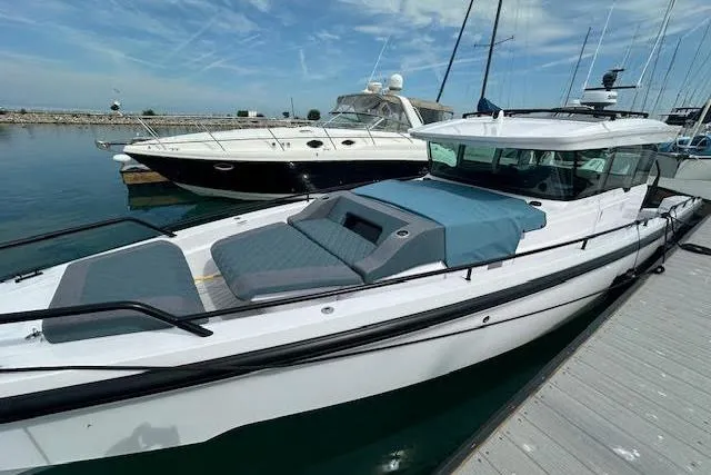 Slide: The Image of 2024 Axopar 37 XC Cross Cabin Wet Bar docked at marina. - 3