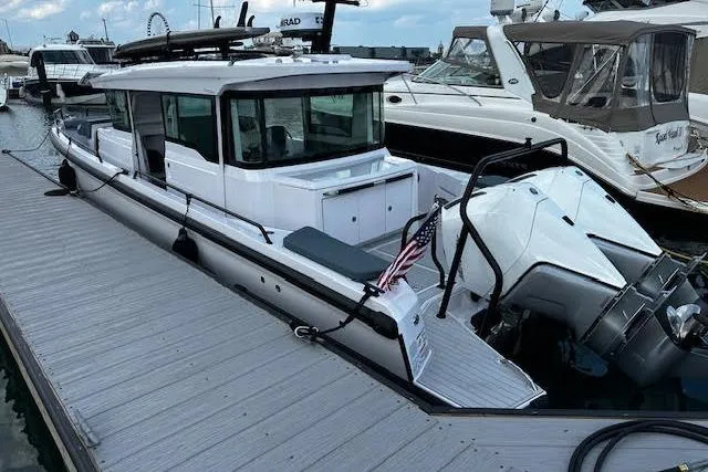 Slide: The Image of 2024 Axopar 37 XC Cross Cabin Wet Bar docked, featuring sleek design and modern amenities. - 4