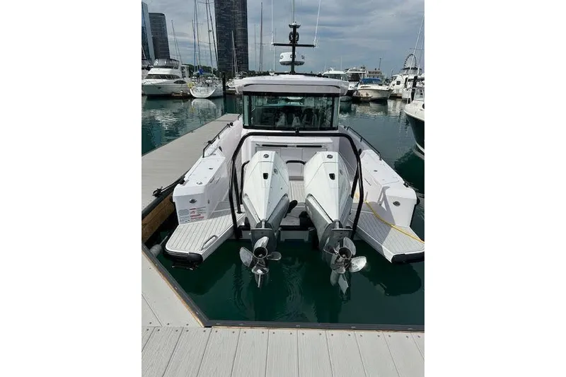 Slide: The Image of 2024 Axopar 37 XC Cross Cabin Wet Bar docked in marina, rear view. - 9