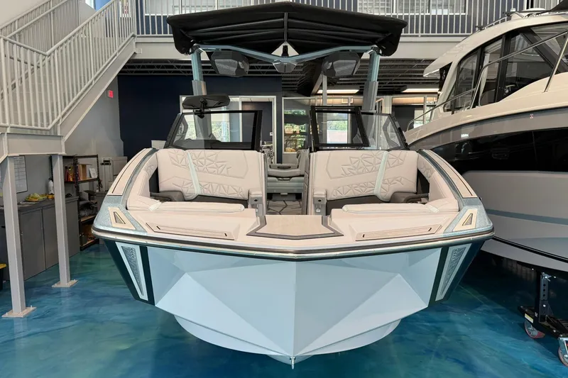 Slide: The Image of 2026 Nautique Super Air Nautique G25 Paragon boat in showroom, front view. - 1