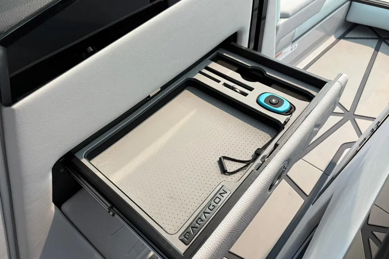 Slide: The Image of 2026 Nautique Super Air Nautique G25 Paragon interior storage compartment with sleek design. - 11