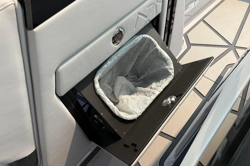 Slide: The Image of 2026 Nautique Super Air Nautique G25 Paragon interior trash compartment detail. - 12