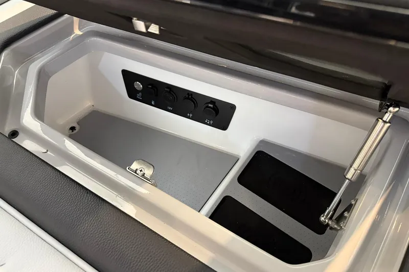 Slide: The Image of Storage compartment with control panel in 2026 Nautique Super Air Nautique G25 Paragon boat. - 13
