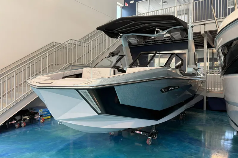 Slide: The Image of 2026 Nautique Super Air Nautique G25 Paragon boat displayed indoors. - 2
