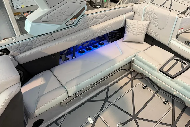 Slide: The Image of Luxurious interior of 2026 Nautique Super Air Nautique G25 Paragon with plush seating and ambient lighting. - 21