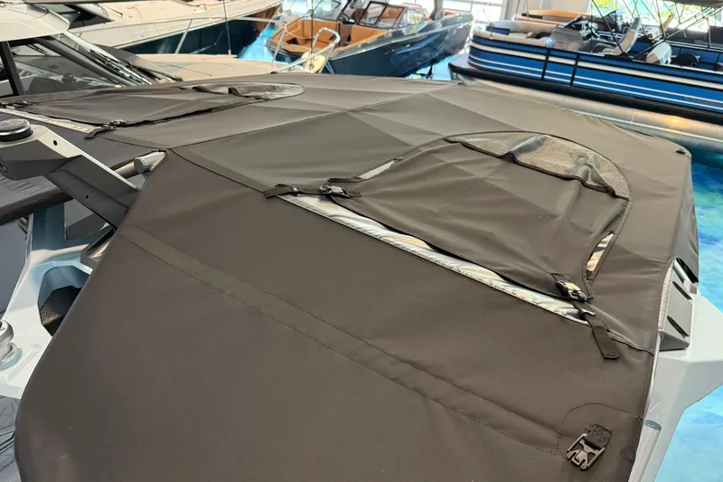 Slide: The Image of 2026 Nautique Super Air Nautique G25 Paragon with protective cover in a showroom. - 27