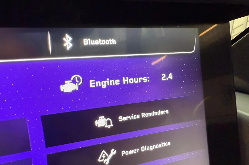 Slide: The Image of Display screen of 2026 Nautique Super Air Nautique G25 Paragon showing engine hours and Bluetooth. - 28