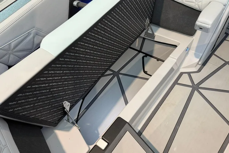 Slide: The Image of 2026 Nautique Super Air Nautique G25 Paragon interior storage compartment with cushioned seating. - 8