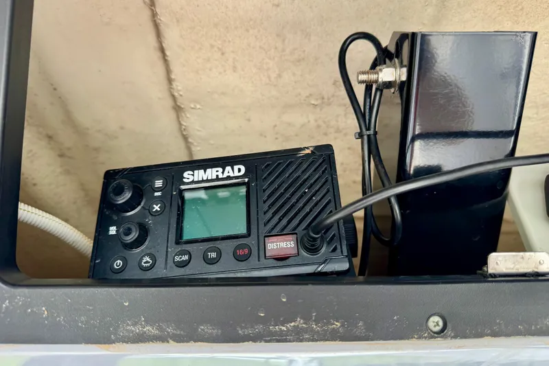 Slide: The Image of Simrad marine radio on 2022 Robalo 266 Cayman boat dashboard. - 14