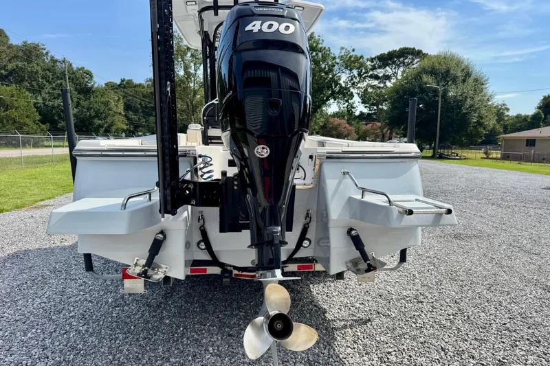 Slide: The Image of 2022 Robalo 266 Cayman boat with powerful 400 horsepower engine, parked on gravel. - 5