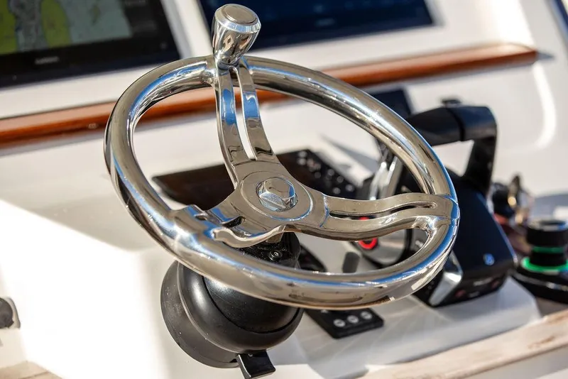 Slide: The Image of 2024 Hinckley Sport Boat 40c docked, showcasing sleek design and modern controls. - 16