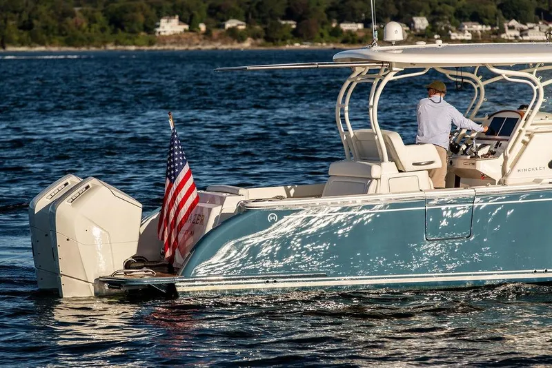 Slide: The Image of 2024 Hinckley Sport Boat 40c cruising on water with American flag. - 2
