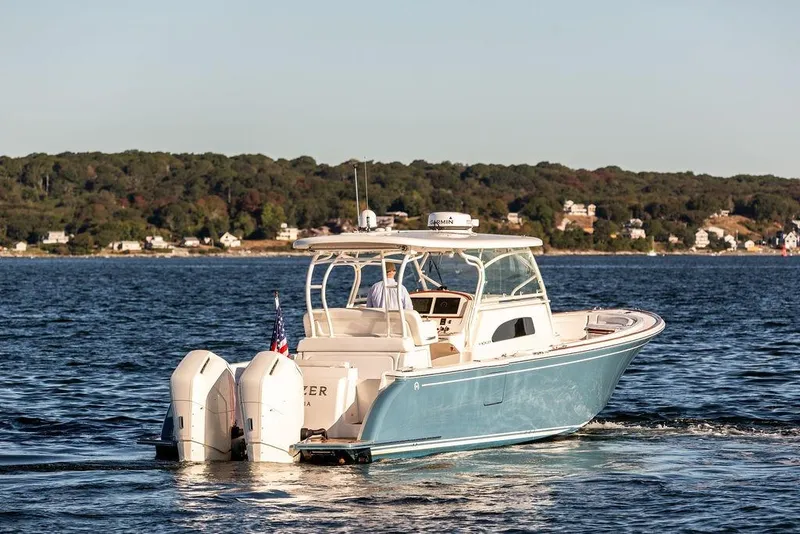 Slide: The Image of 2024 Hinckley Sport Boat 40c deck with seating, overlooking calm water. - 26