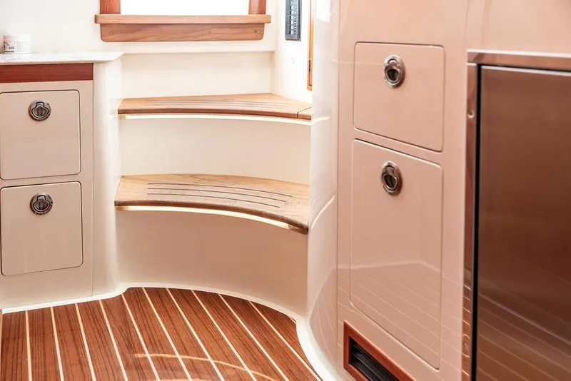 Slide: The Image of 2024 Hinckley Sport Boat 40c interior with modern sink and countertop. - 36
