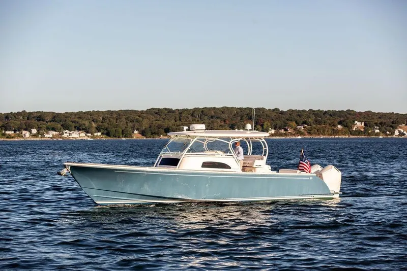 Slide: The Image of 2024 Hinckley Sport Boat 40c docked at marina, showcasing sleek design and luxury features. - 13