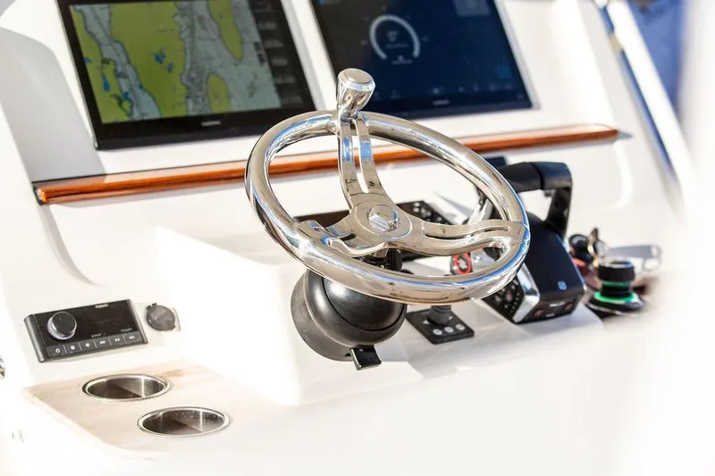 Slide: The Image of 2024 Hinckley Sport Boat 40c docked, showcasing sleek design and modern controls. - 15