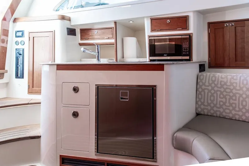 Slide: The Image of 2024 Hinckley Sport Boat 40c interior with modern kitchen and seating area. - 30