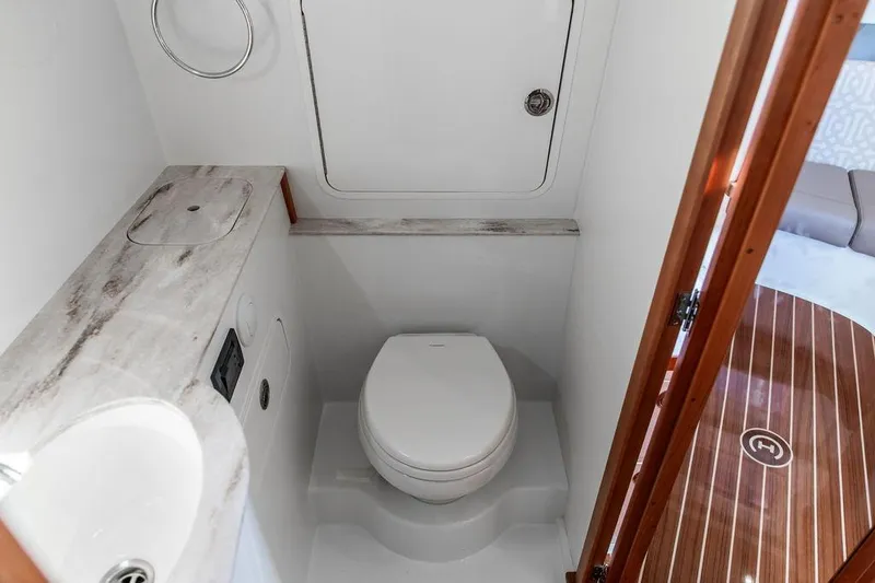Slide: The Image of 2024 Hinckley Sport Boat 40c bathroom with modern fixtures and wooden accents. - 37