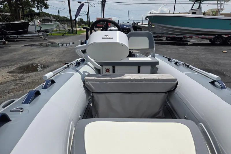 Slide: The Image of 2025 Highfield Classic 360 inflatable boat interior with steering console and seating. - 10