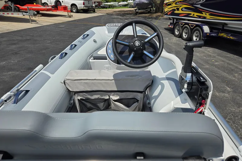 Slide: The Image of Interior view of 2025 Highfield Classic 360 boat, featuring steering wheel and controls. - 12