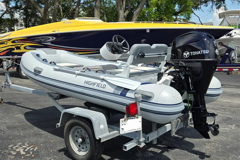 Slide: The Image of 2025 Highfield Classic 360 inflatable boat with Tohatsu motor on trailer. - 6