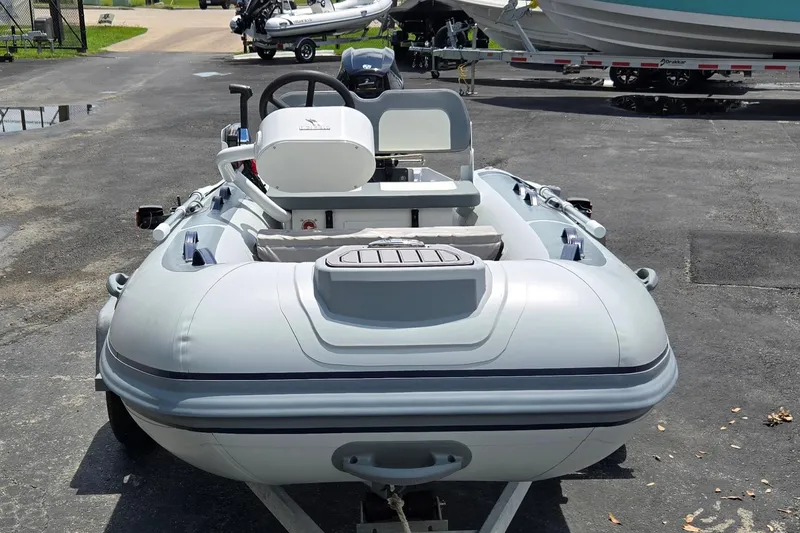 Slide: The Image of 2025 Highfield Classic 360 inflatable boat on trailer, parked outdoors. - 9